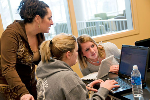 People researching on several laptops