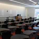 A view of the front of the classroom showing classroom podium and whiteboards.