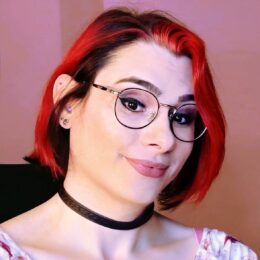 Woman with red hair and glasses