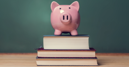 piggy bank sitting on a stack of books